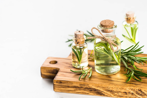 Rosemary essential oil in the bottle on white. - Foto, Imagen