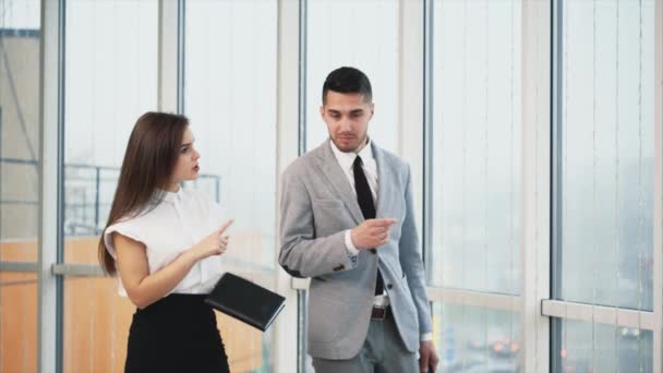 Two business people are going along on white blurred panoramic background. Blurred beginning. Close up. Copy space. 4K. - Footage, Video