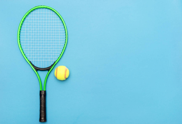 Vista superior de raquetes de tênis e bola no fundo azul
.  - Foto, Imagem