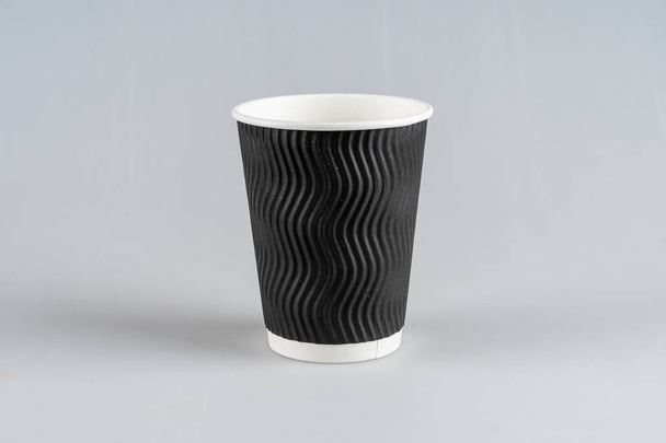 Disposable, cardboard black Cup isolated on a white background. - Photo, Image