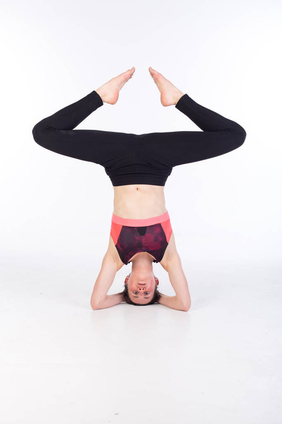 donna in leggings e reggiseno sportivo si allunga e pratica yoga
 - Foto, immagini