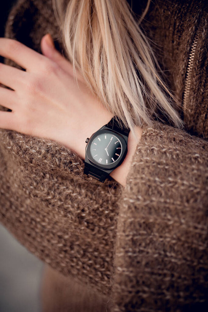 Stylish black watch on woman hand - Foto, imagen