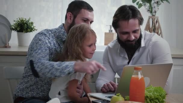 Gay Couple with Daughter Looking at Laptop
 - Кадры, видео