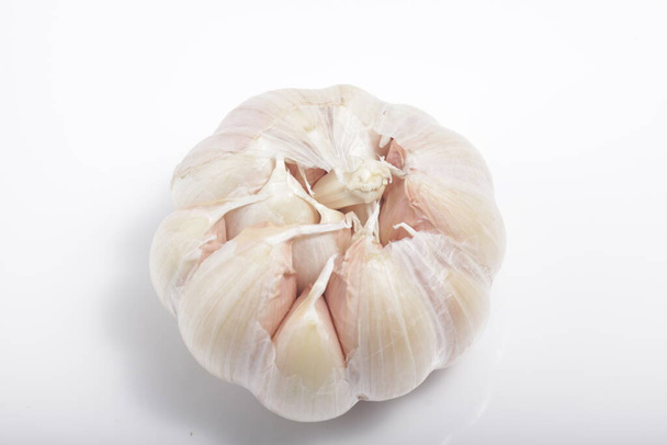 Close - up shot of garlic on a white isolated background - Fotó, kép