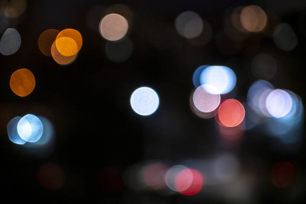 abstract bokeh background in the form of multi -colored circles on a black background. - 写真・画像