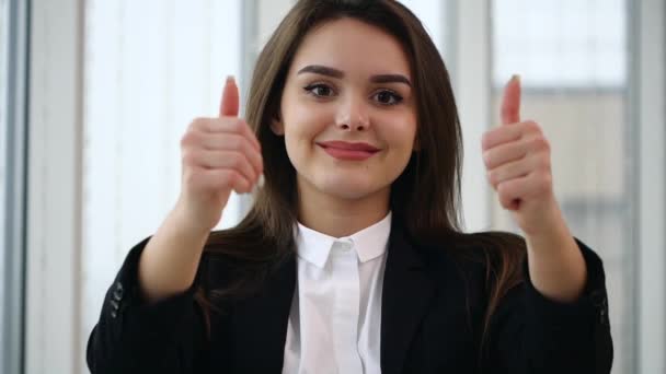 Business woman smiling for camera with her thumb fingers up, isolated on white panoramic background. Close up. Copy space. Slow motion. 4K. - Πλάνα, βίντεο