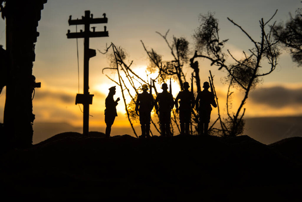 War Concept. Military silhouettes fighting scene on war fog sky background, World War Soldiers Silhouette Below Cloudy Skyline At sunset. Battle in ruined city. Selective focus - Photo, Image