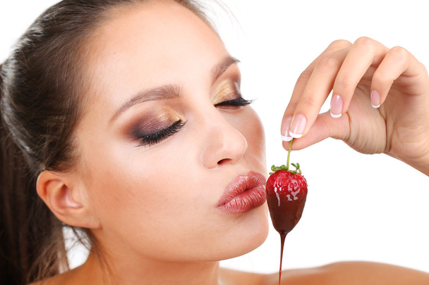 Portrait of beautiful young girl with strawberry in chocolate - Photo, image