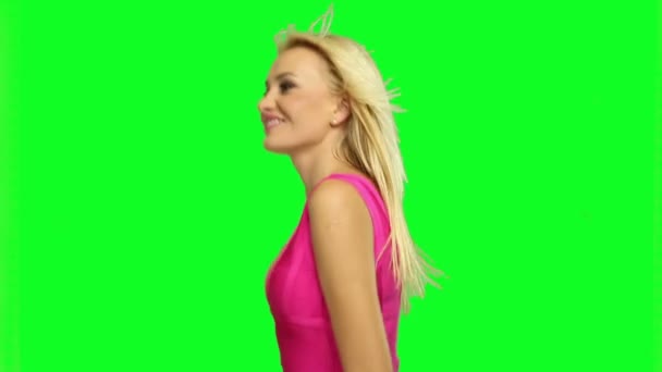 Blond woman dancing, on fluorescent background - Footage, Video
