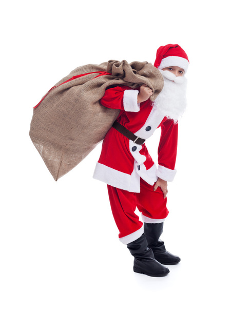 Santa carrying his large bag - isolated - Foto, afbeelding