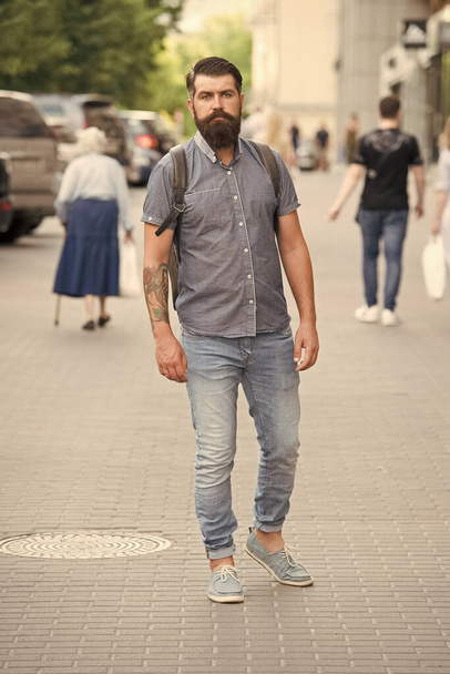 Mature hipster with beard. Bearded man. Confident brutal man walk street. Male hair barber care. brutal hipster with hiking backpack. adventure concept. urban style. Adventure awaits, go find it - Fotó, kép