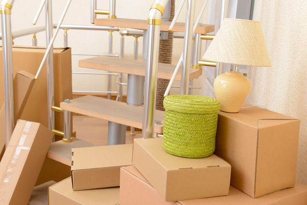 Stack of cartons near stairs: moving house concept - Fotografie, Obrázek