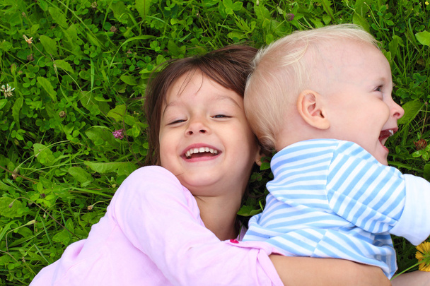 Happy little girl hugging her brother - Fotografie, Obrázek