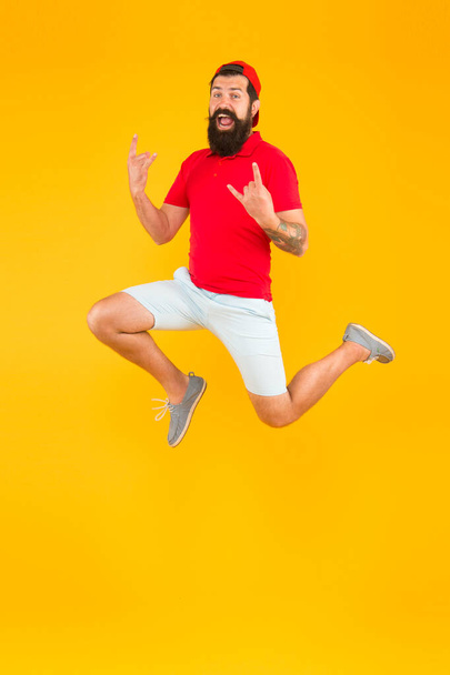 Energy charge. Healthy guy feeling good. Inspired concept. Always in motion. Enjoying active lifestyle. Happy guy jumping. Active bearded man in motion yellow background. Active and energetic hipster - Photo, Image