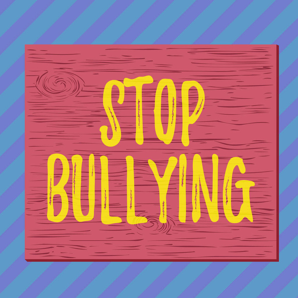 Handwriting text writing Stop Bullying. Concept meaning stop the aggressive behaviour among school aged children Square rectangle unreal cartoon wood wooden nailed stuck on coloured wall. - Photo, Image