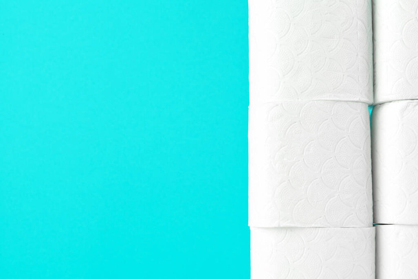 Toilet paper rolls on turquoise bright background - Fotoğraf, Görsel