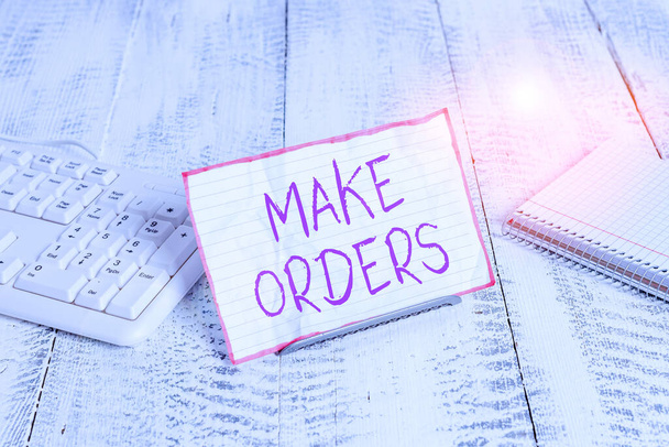 Conceptual hand writing showing Make Orders. Business photo showcasing A confirmed request by one party to another to buy or sell Notepaper on wire in between computer keyboard and sheets. - Photo, Image