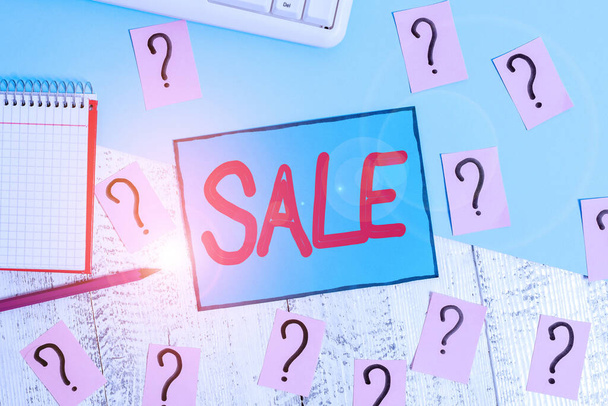 Text sign showing Sale. Conceptual photo event of putting products on high discount Great price Black Friday Writing tools, computer stuff and math book sheet on top of wooden table. - Fotoğraf, Görsel