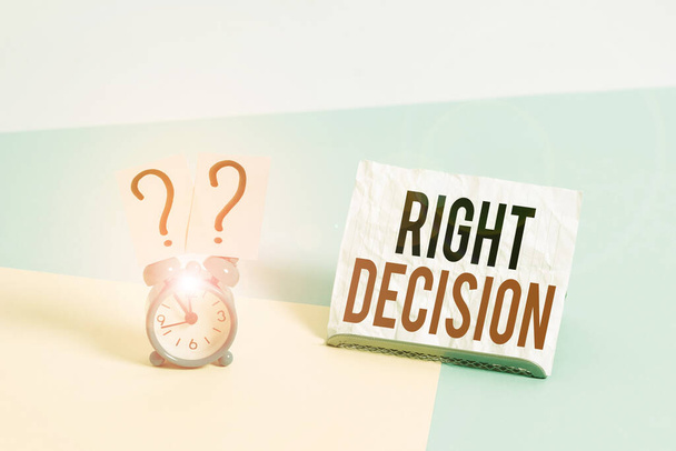 Writing note showing Right Decision. Business photo showcasing making good choice after considering a lot of possibilities Alarm clock beside a Paper sheet placed on pastel backdrop. - Photo, Image