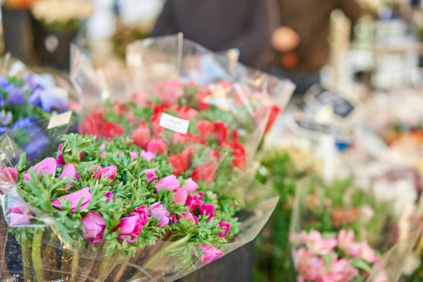Bunches of different colorful flowers in buckets on street flower market in Anemone, poppy - Foto, Imagen
