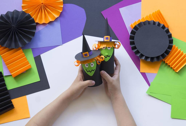 Halloween holiday witch made of paper. Children's creativity. Hobby craft material - Fotó, kép