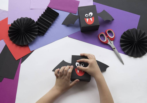 Halloween holiday bat made of paper. Children's creativity. Hobby craft material - Fotó, kép