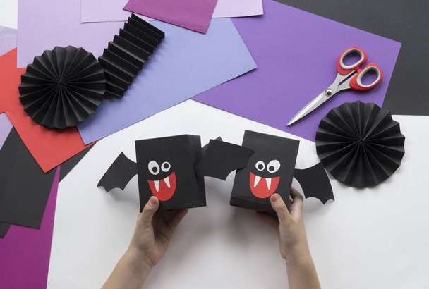Halloween holiday bat made of paper. Children's creativity. Hobby craft material - Fotó, kép