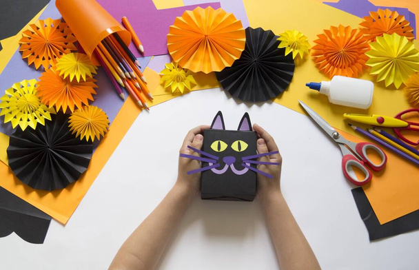 Halloween holiday black cat made of paper. Children's creativity. Hobby craft material - Foto, immagini