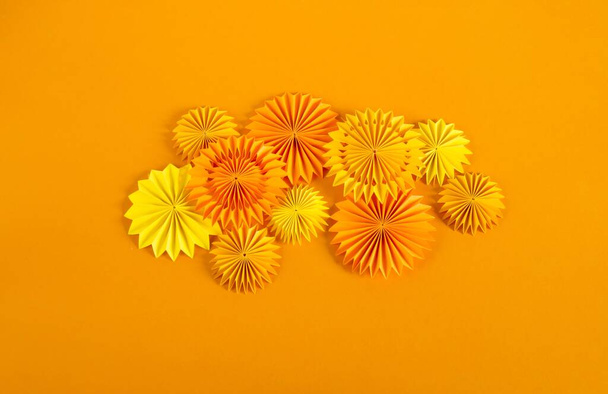 Orange garland made of paper. Bright birthday decor for the holiday. - Photo, Image