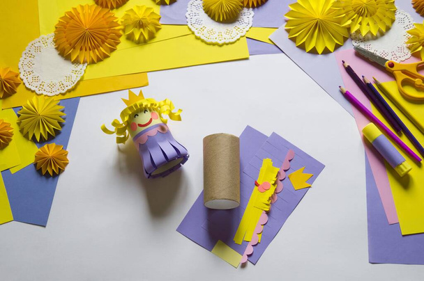 Princess made of paper. White background. Children's hands favorite hobby - Φωτογραφία, εικόνα