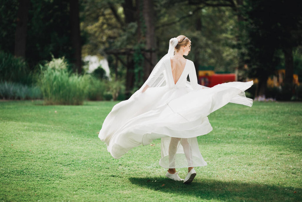 Beautiful bride posing in wedding dress outdoors - Φωτογραφία, εικόνα