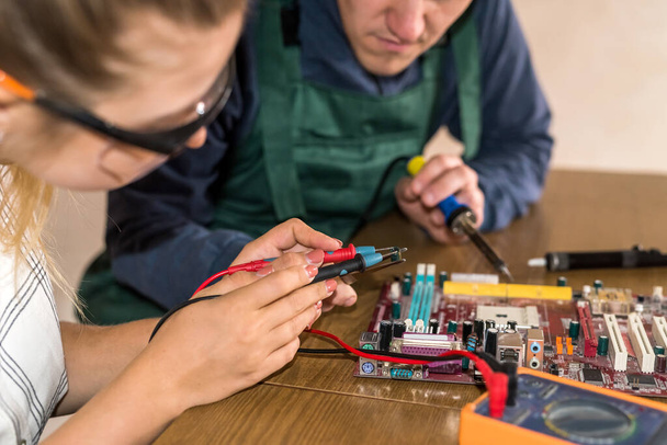 Engineers working with motherboard repairing some details - Фото, зображення