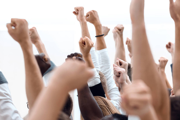cropped image of a multiracial group of people holding their hands up. - Foto, afbeelding