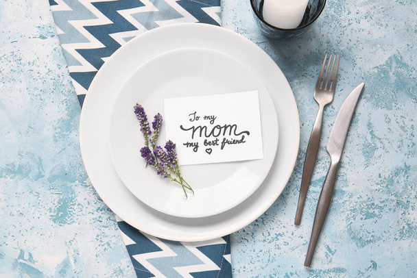 Table setting with card for Mother's day dinner on color background - Foto, Imagen