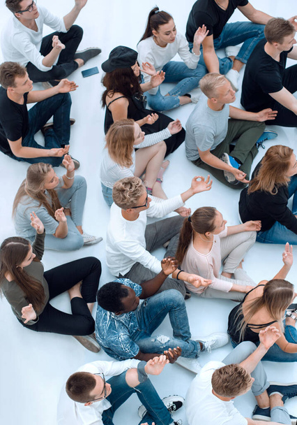 group of diverse young people meditate sitting on the floor. - Valokuva, kuva