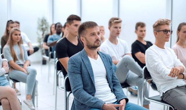 casual young man sitting among the seminar listeners - Photo, image