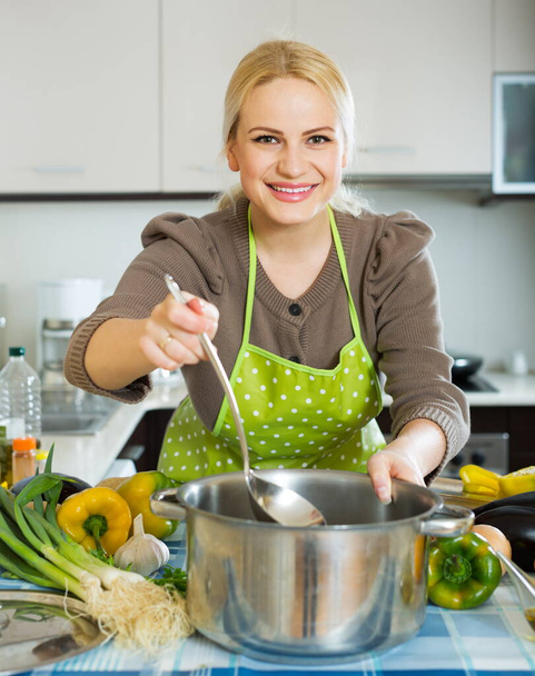 Portrait of happy girl cooking with vegetables - Foto, Imagem