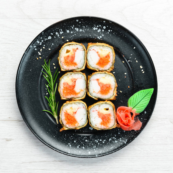 Sushi with crab and caviar cooked in oil. Sushi menu of Japanese restaurant. Top view. - 写真・画像