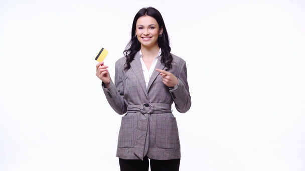 Businesswoman showing credit card and smiling isolated on white - Footage, Video