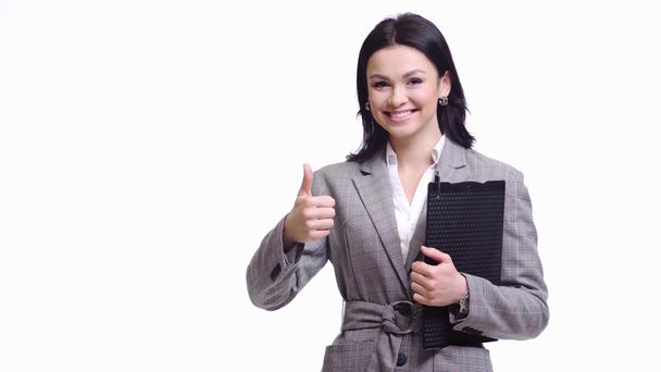 Businesswoman holding clipboard, smiling and showing like sign isolated on white - Materiał filmowy, wideo