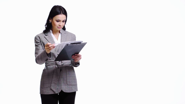 Businesswoman writing on documents isolated on white - Footage, Video