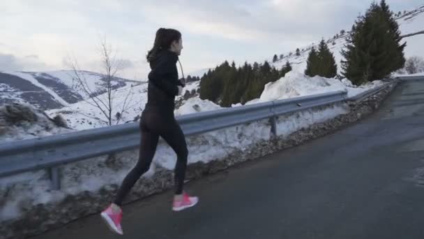 Jogger em treino de sportswear na montanha nevada no pôr do sol
 - Filmagem, Vídeo