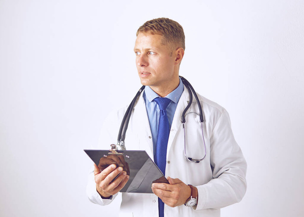 Young confident doctor in a white coat with a stethoscope - 写真・画像