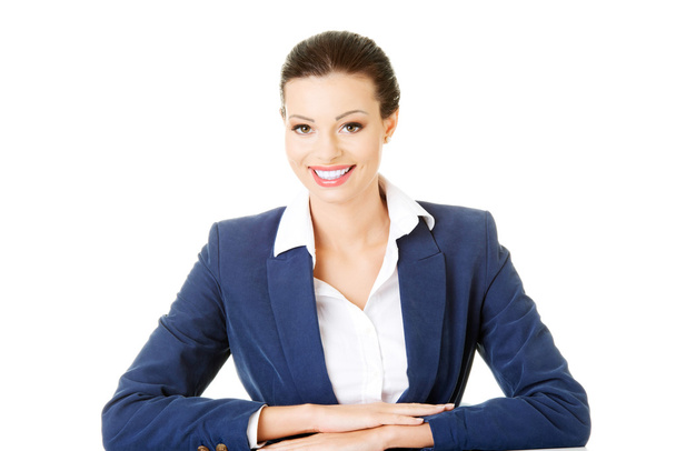 Attractive business woman sitting and smiling. - Photo, Image