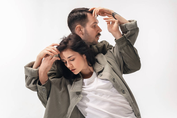 Trendy fashionable couple isolated on white studio background - Фото, изображение