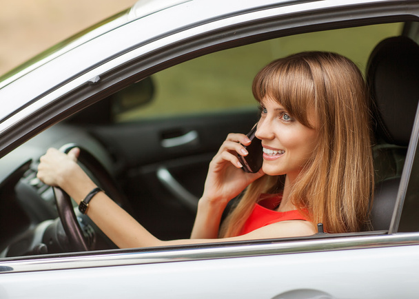 Businesswoman in the car on the phone. - Photo, image