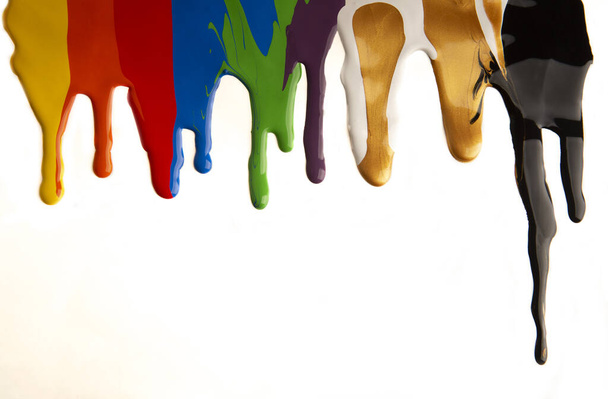 Colorful paint dripping isolated on a white background - Photo, Image