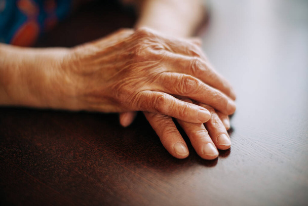hands of real senior woman at home , natural light , selective focus point - Foto, Bild