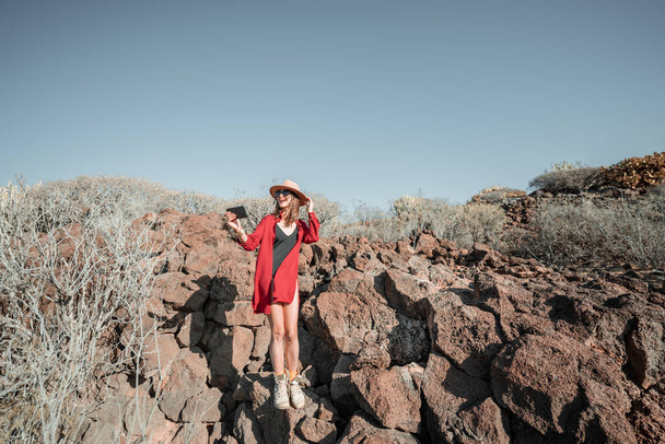 Woman on a desert rocky landscape - Fotoğraf, Görsel