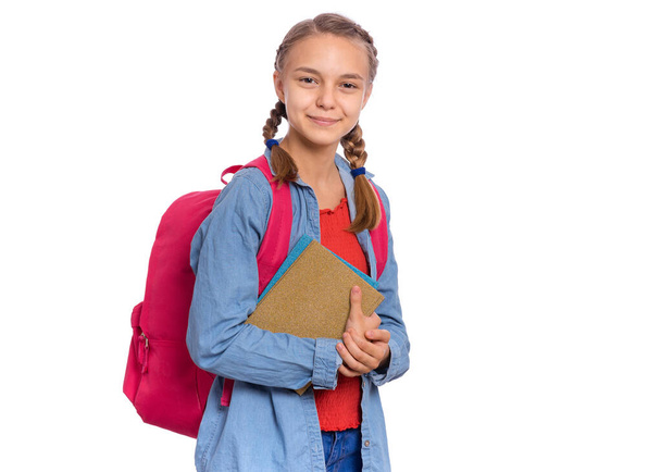 Beautiful student teen girl with backpack holding books, looking at camera. Portrait of cute smiling schoolgirl with bag, isolated on white background. Happy child Back to school. - Photo, image